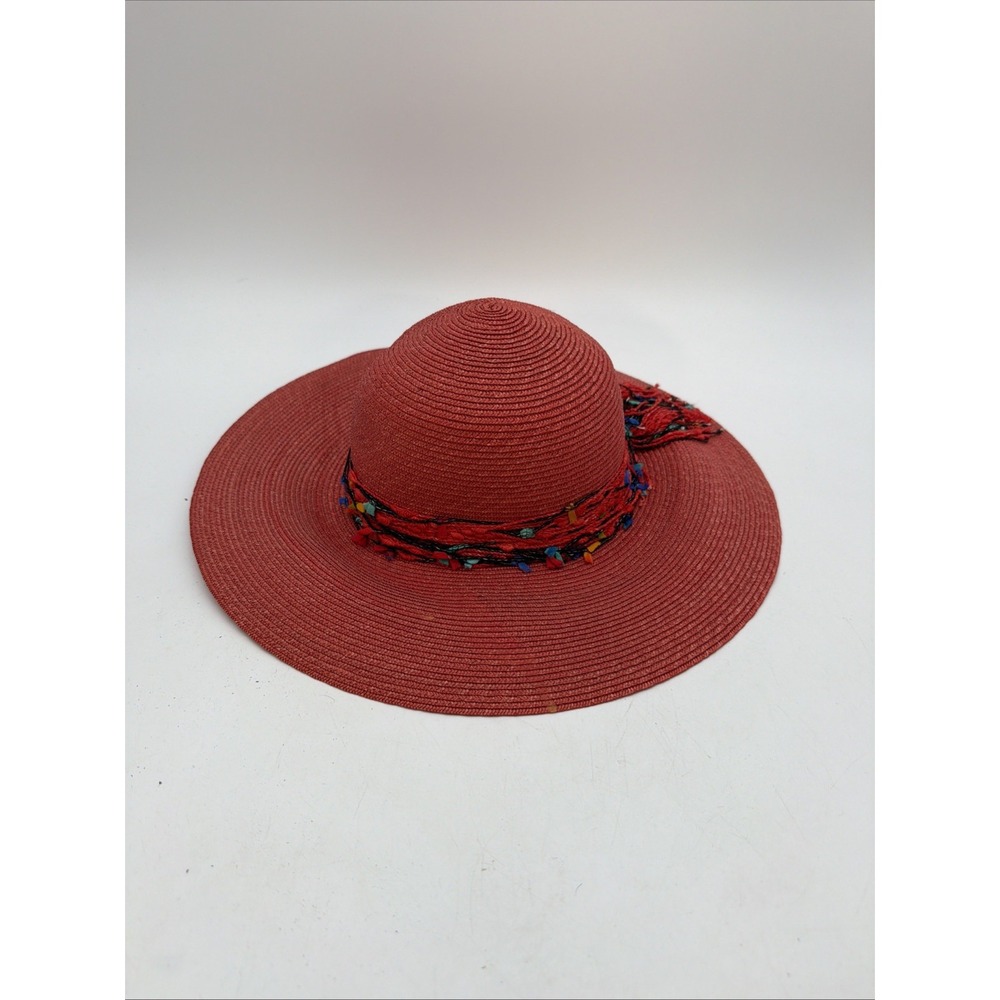 red wide-brim straw sun hat accented with a multicolored woven trim